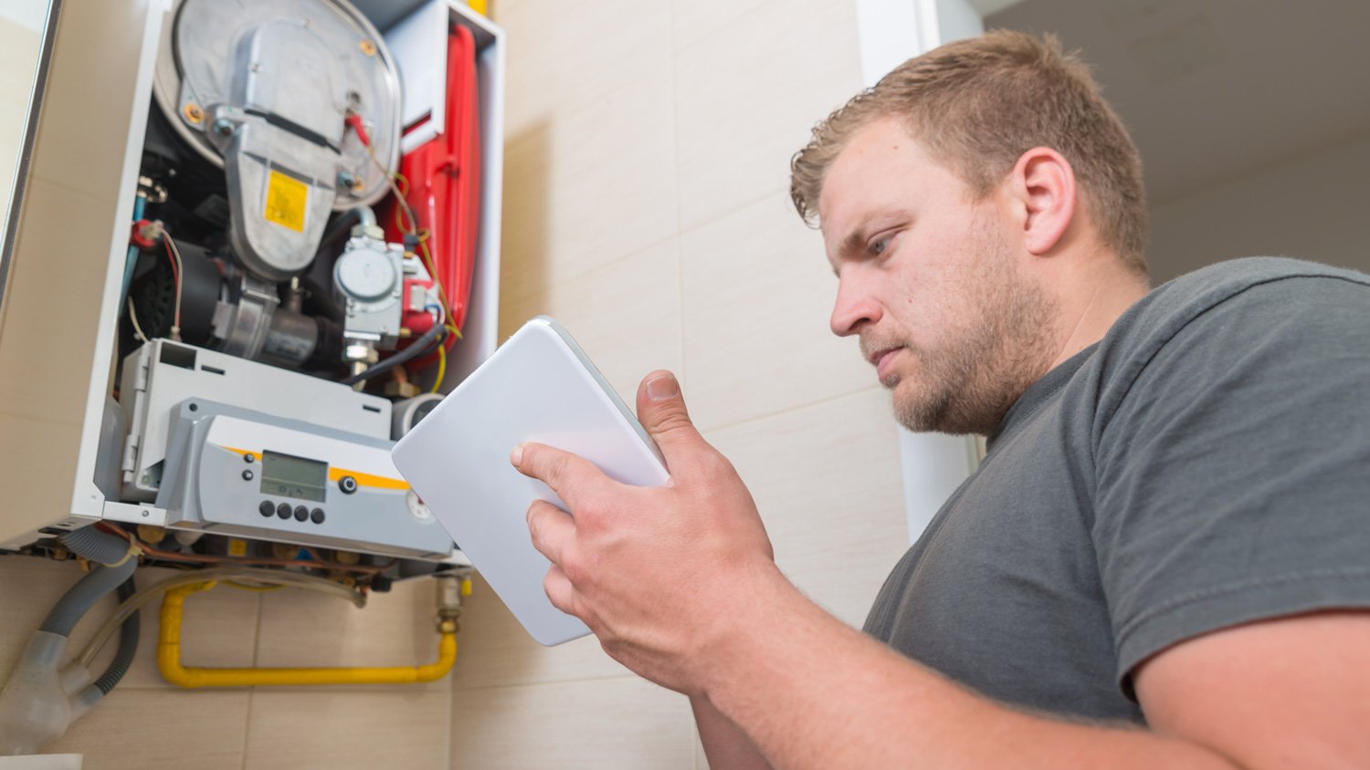 A man inspecting a boiler