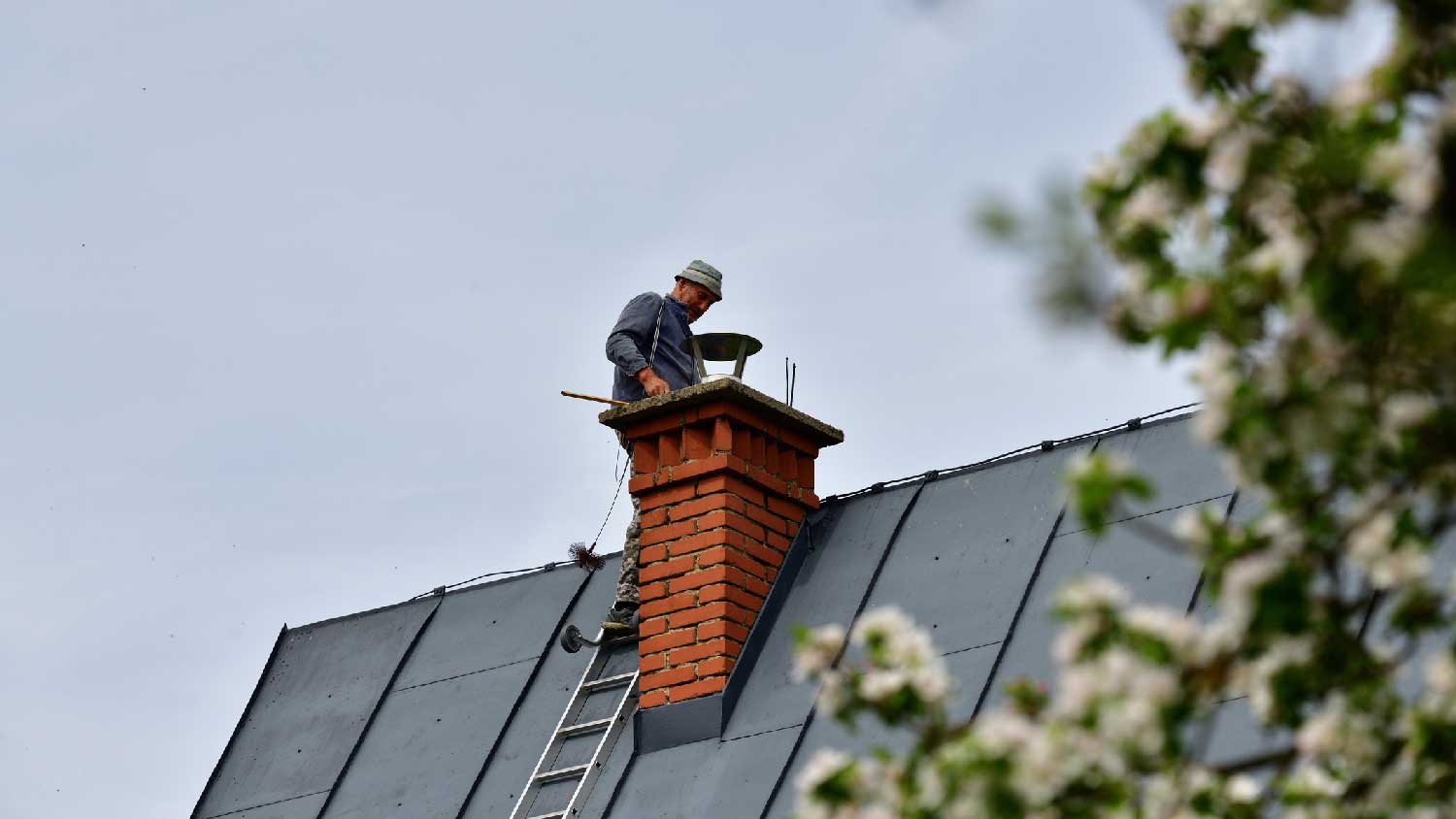 A man inspecting a chimney