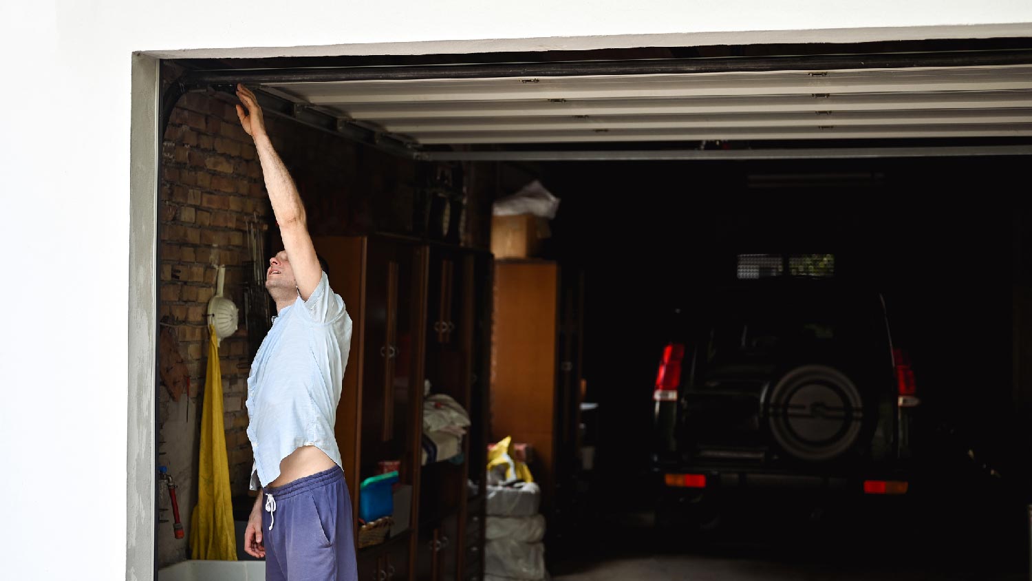 A man inspecting a garage door