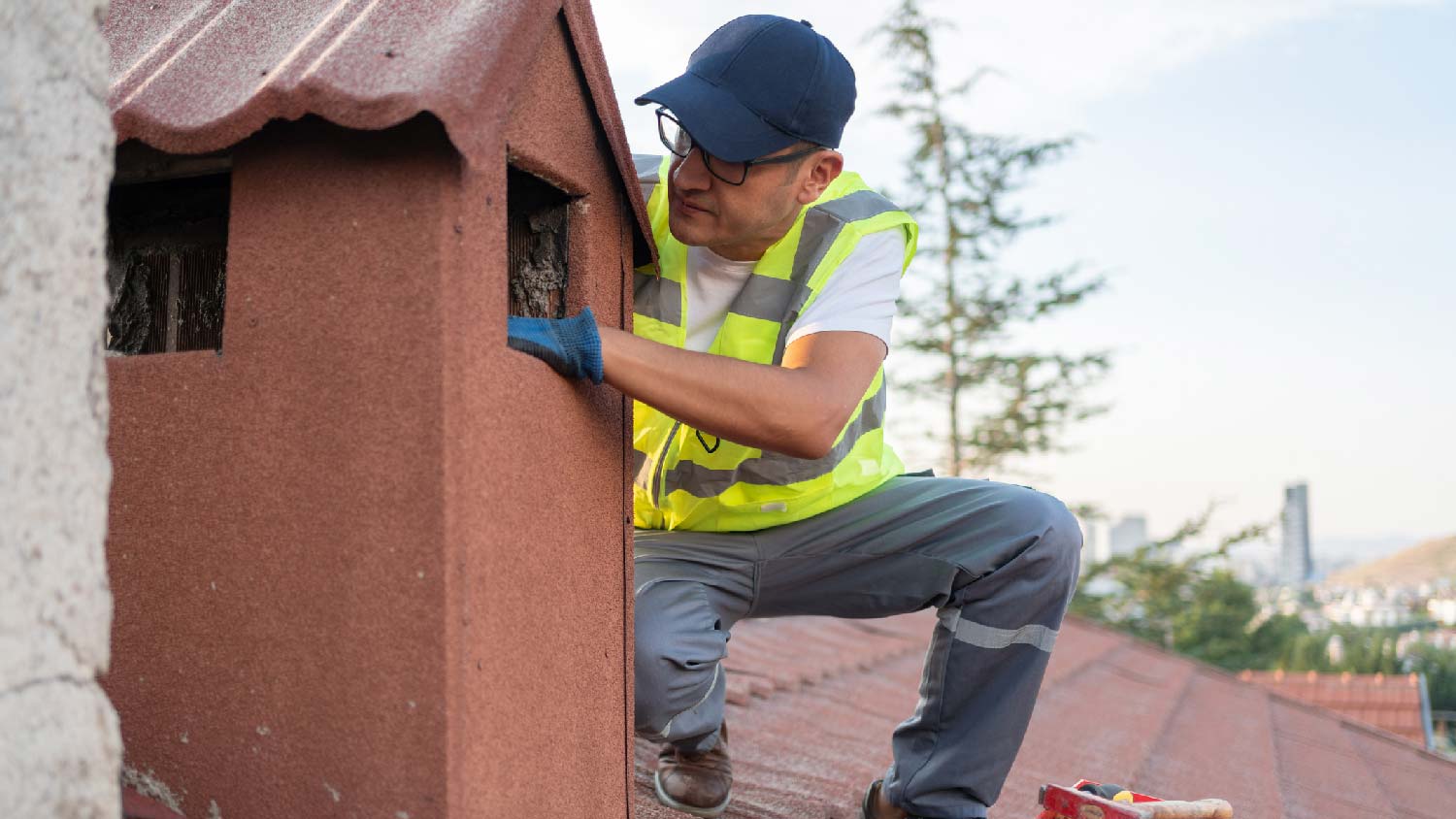 A man inspecting a leaking chimney