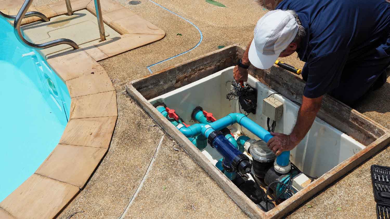 A man inspecting a pool pump