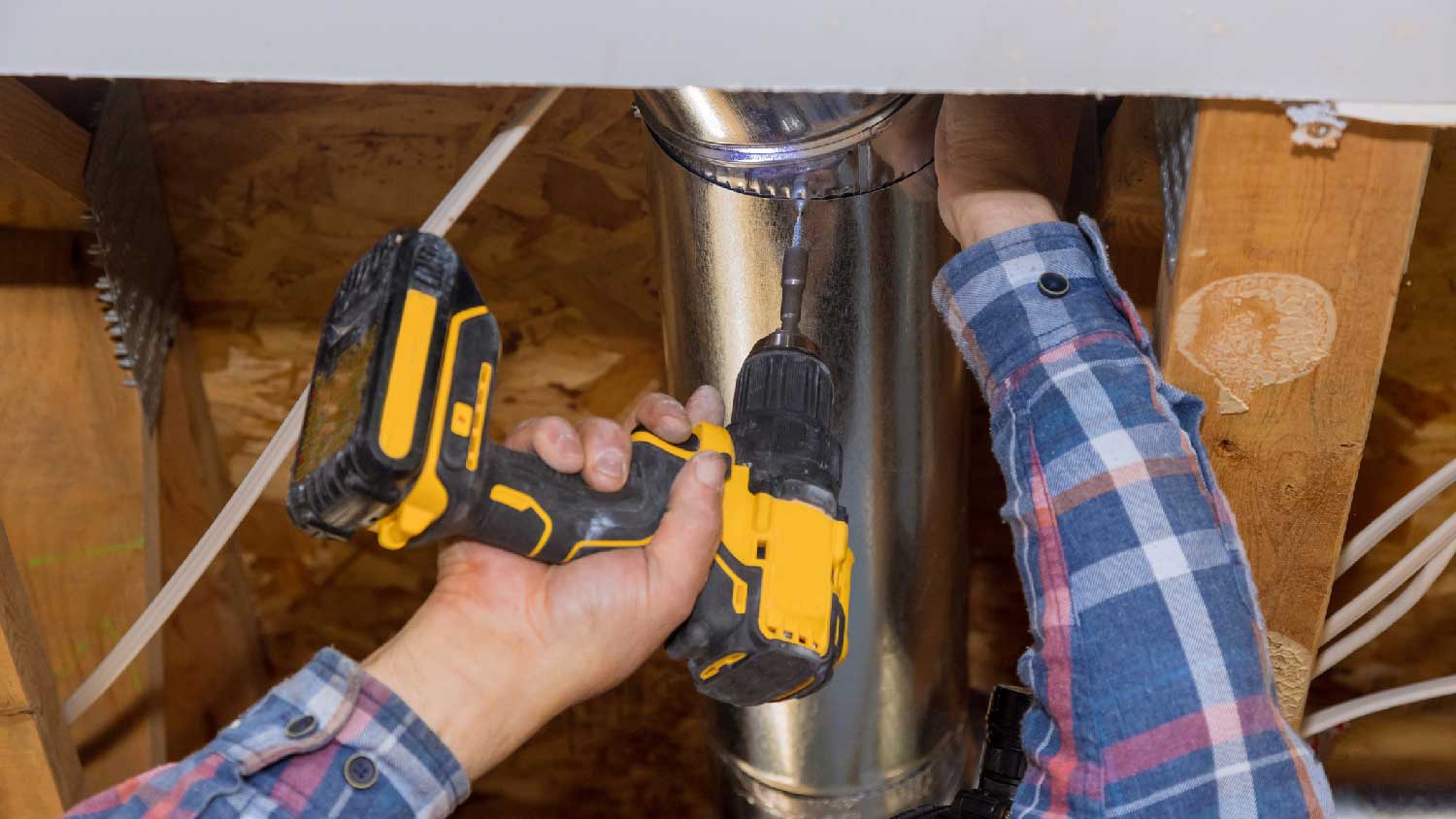 A man installing an aluminum ductwork