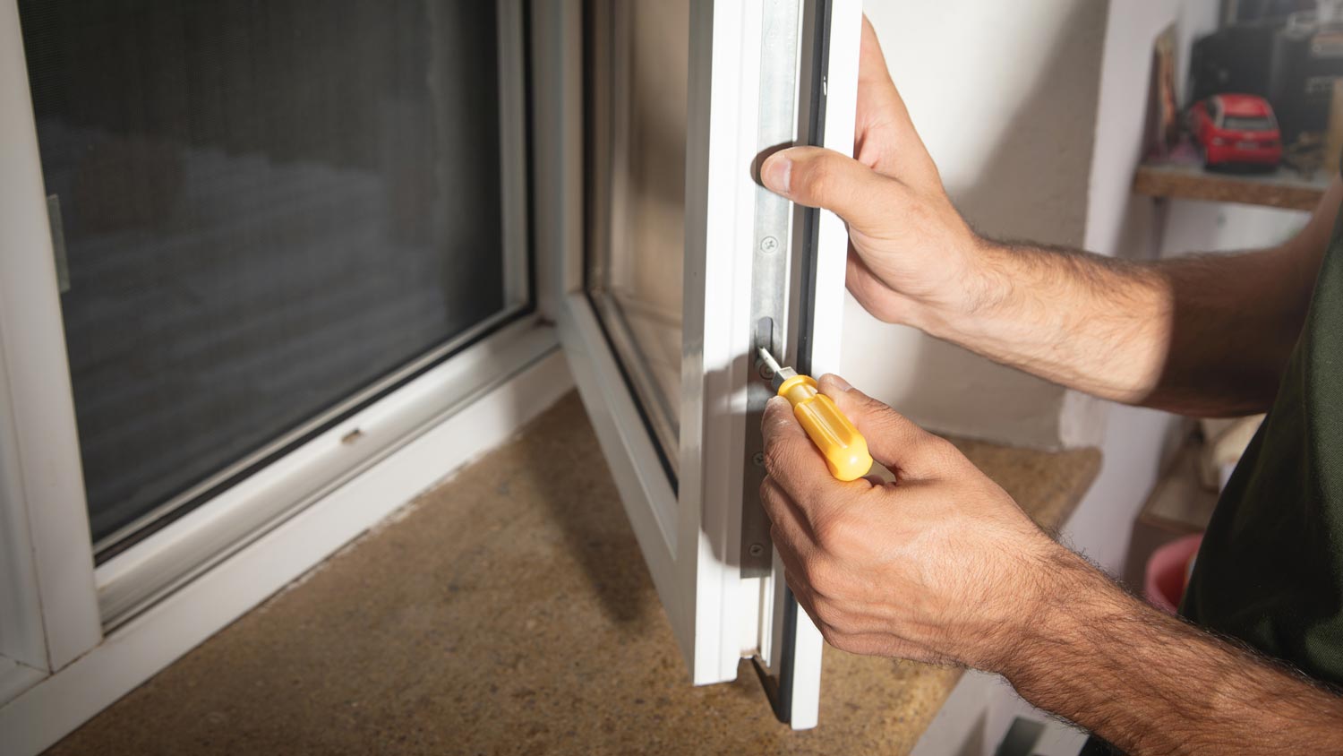 A man installing a casement window