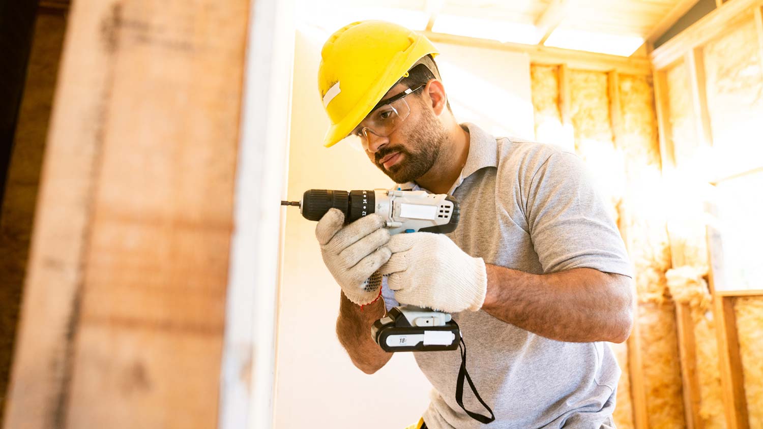 A man installing a drywall