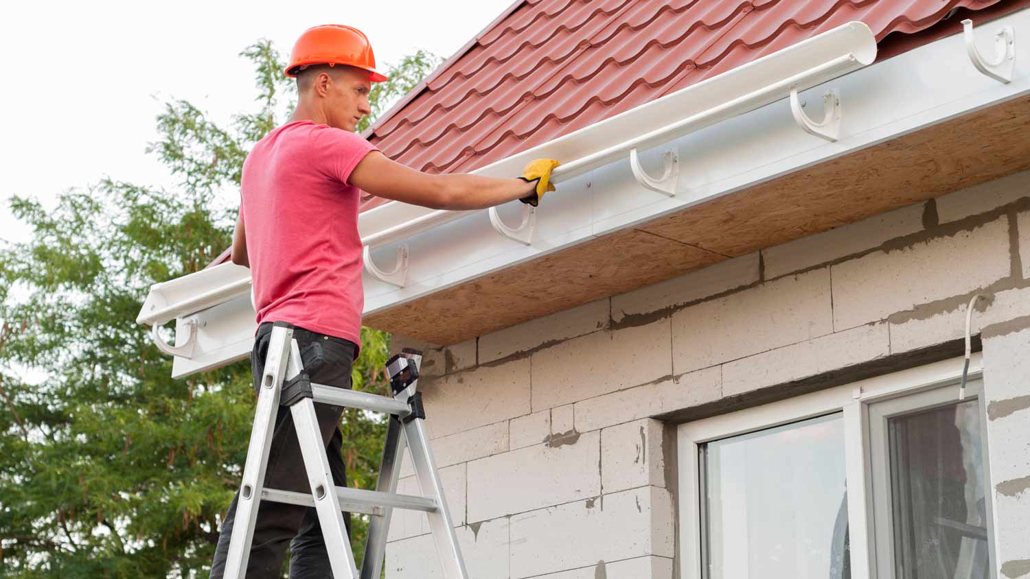 man installing gutter system