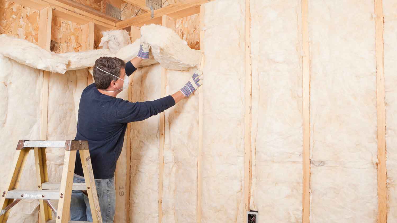 Man installing mineral wool insulation