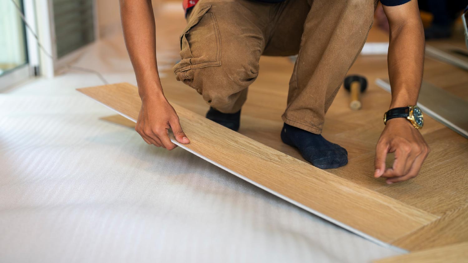  A man installing laminate planks