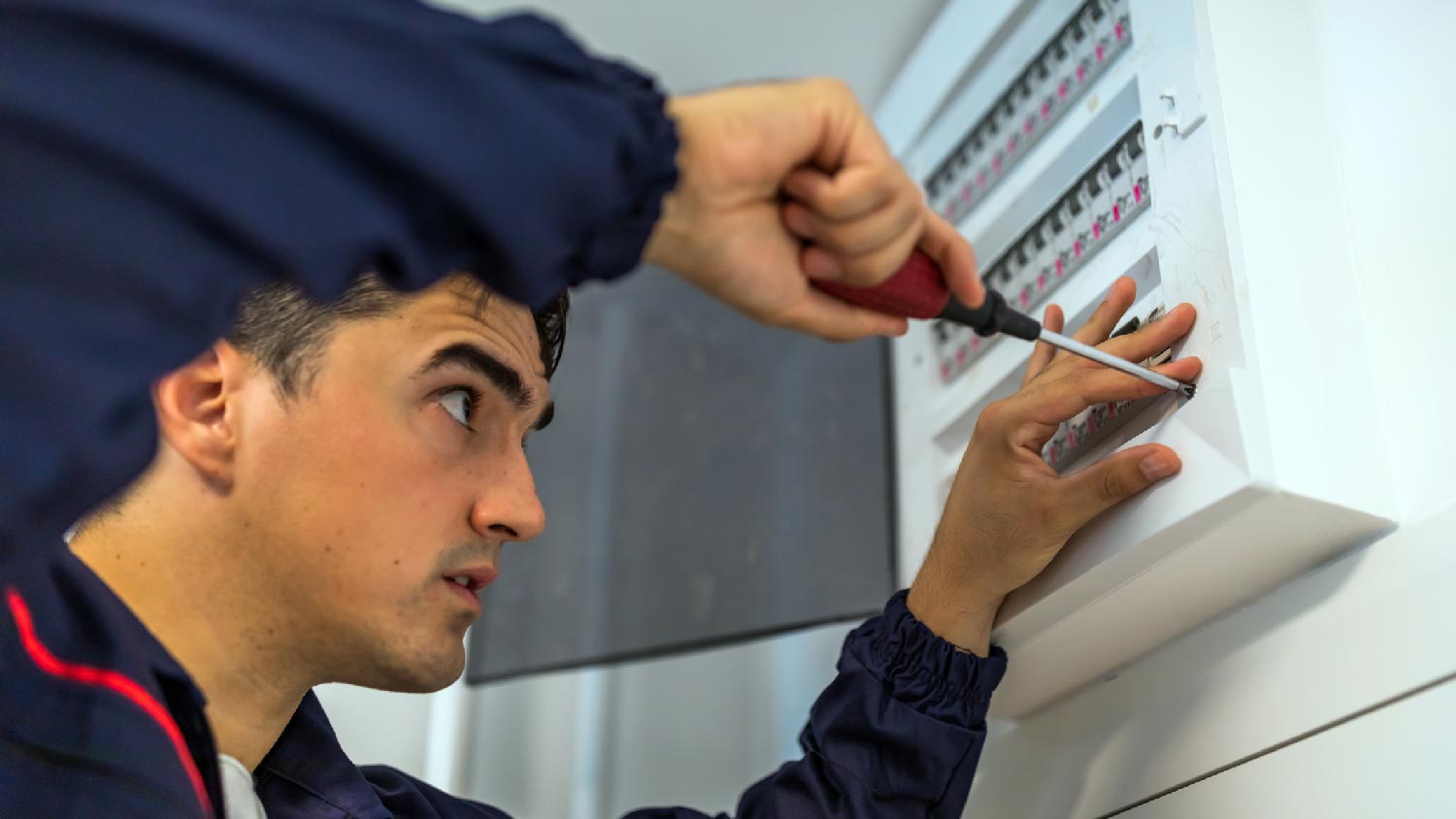 A man installing new electrical panel