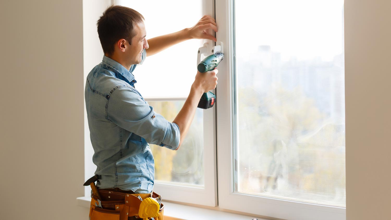 A man installing a new window