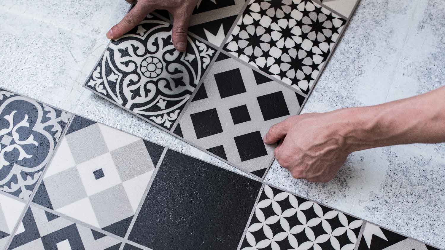  A man installing peel-and-stick tiles