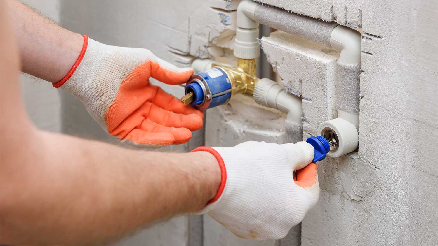 detail of a man installing a plug on faucet