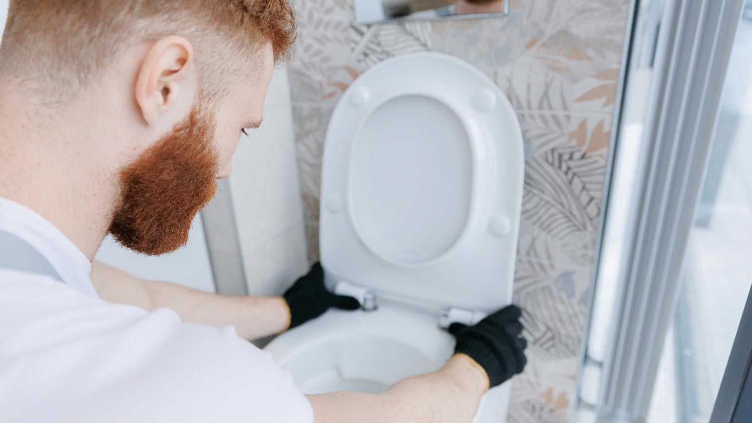 A man installing a wall hung toilet