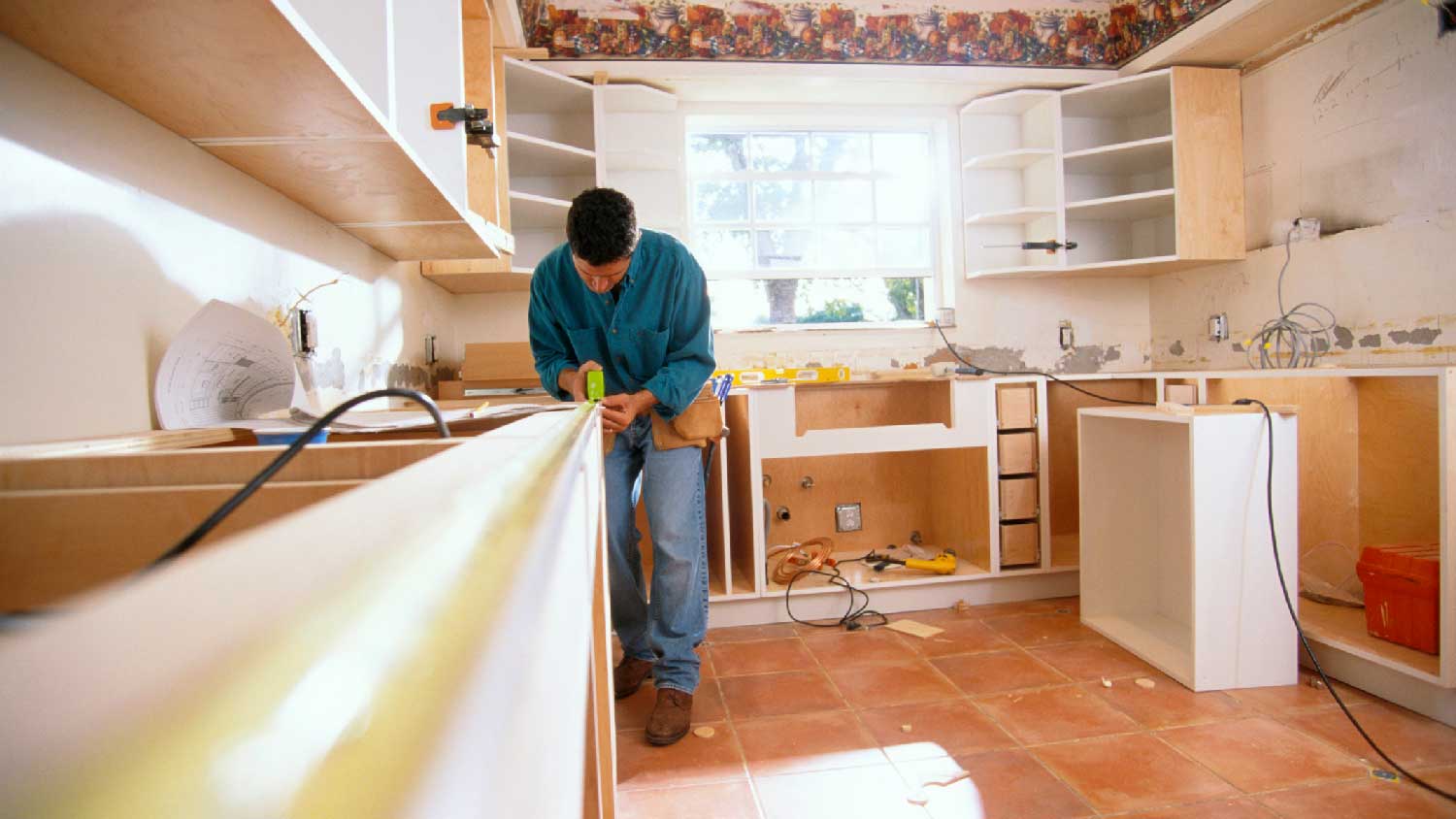 A man measuring a counter