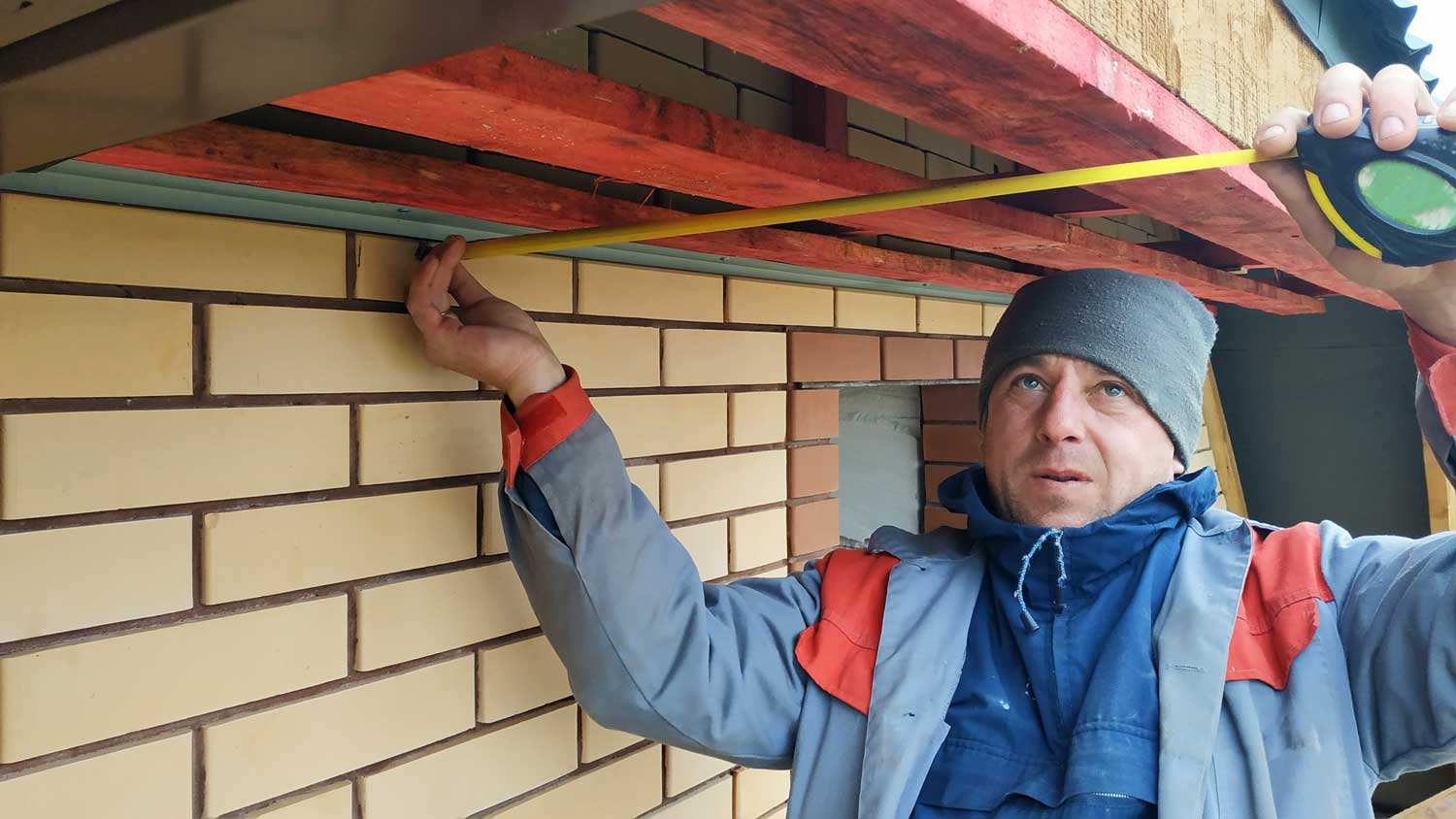 Man measuring eaves for soffit