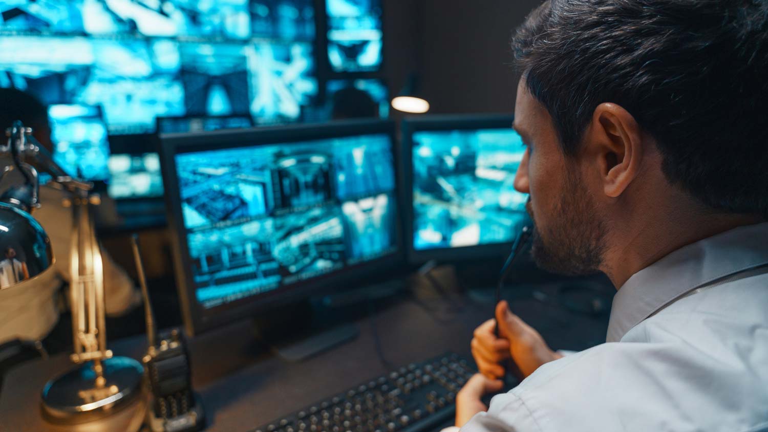 A man monitoring a house’s cameras