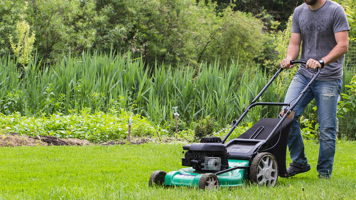 man mowing front lawn