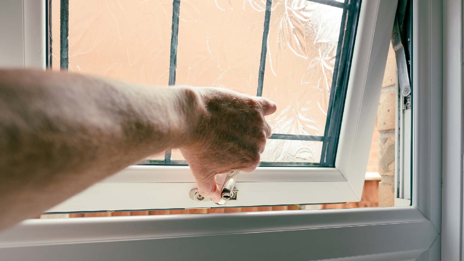 A man opening the bathroom window