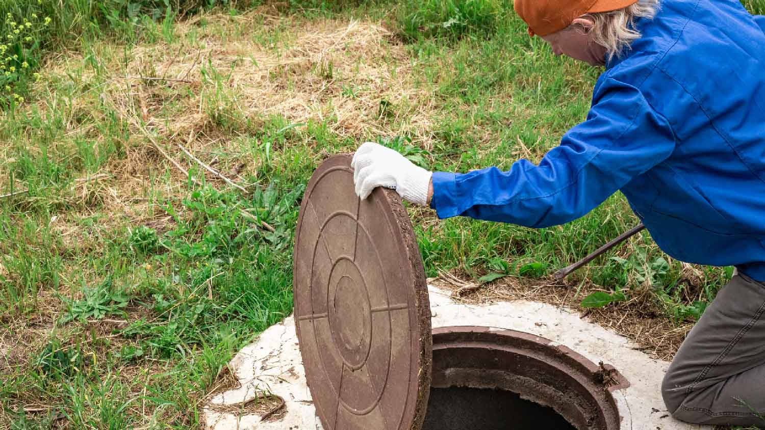  A man opening a cesspool