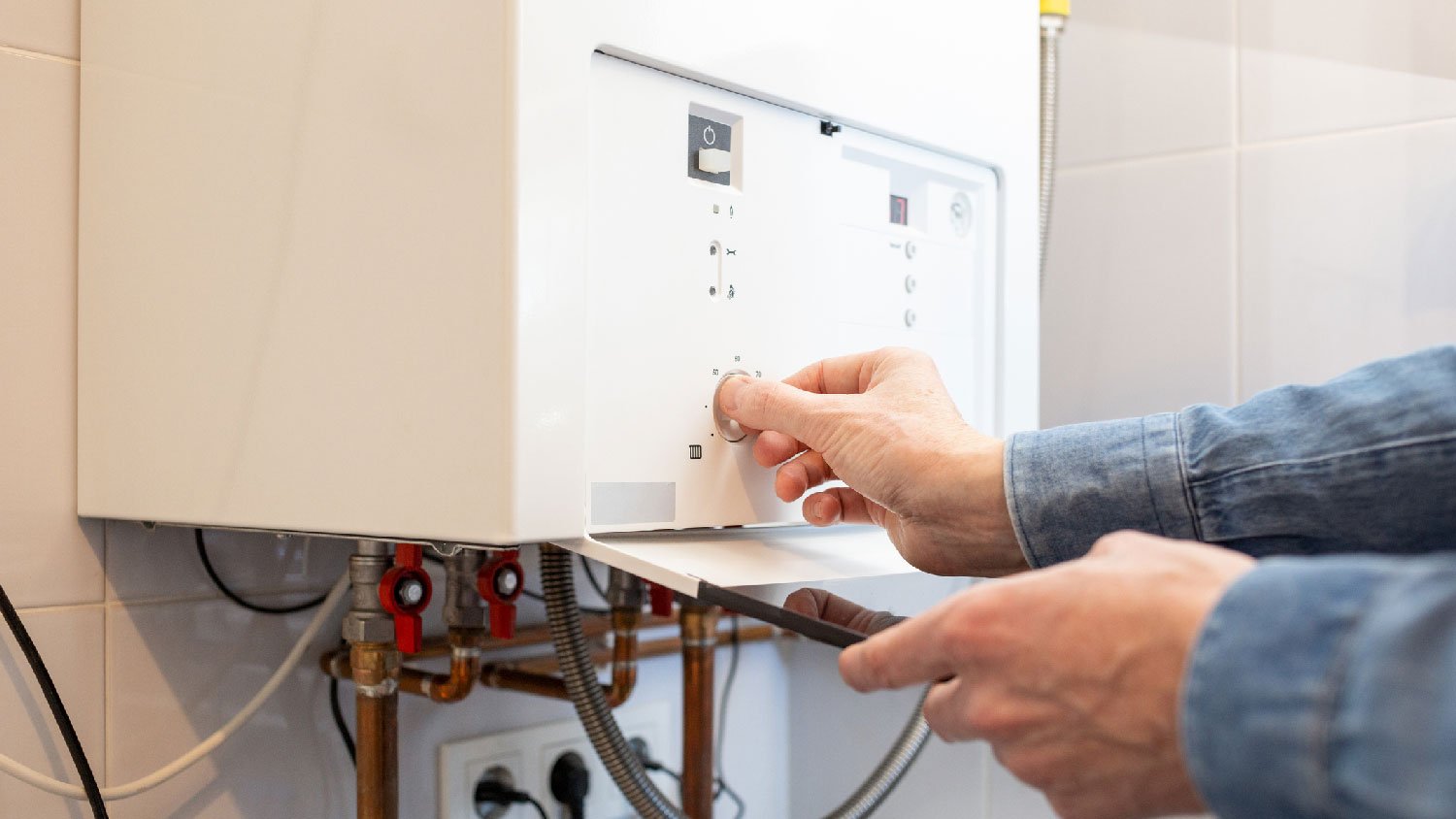 A man operating a gas water heater