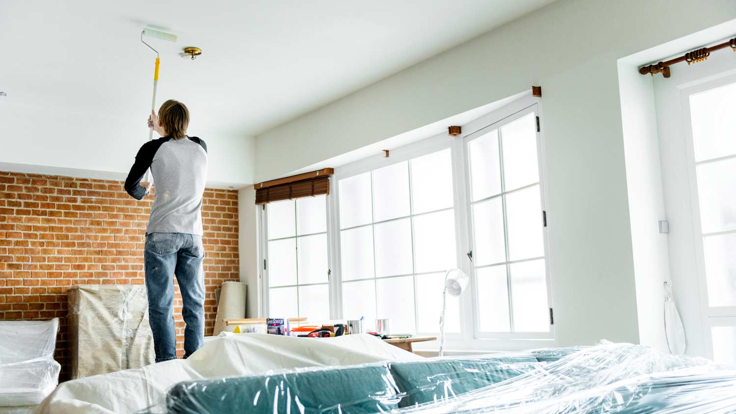 man painting ceiling