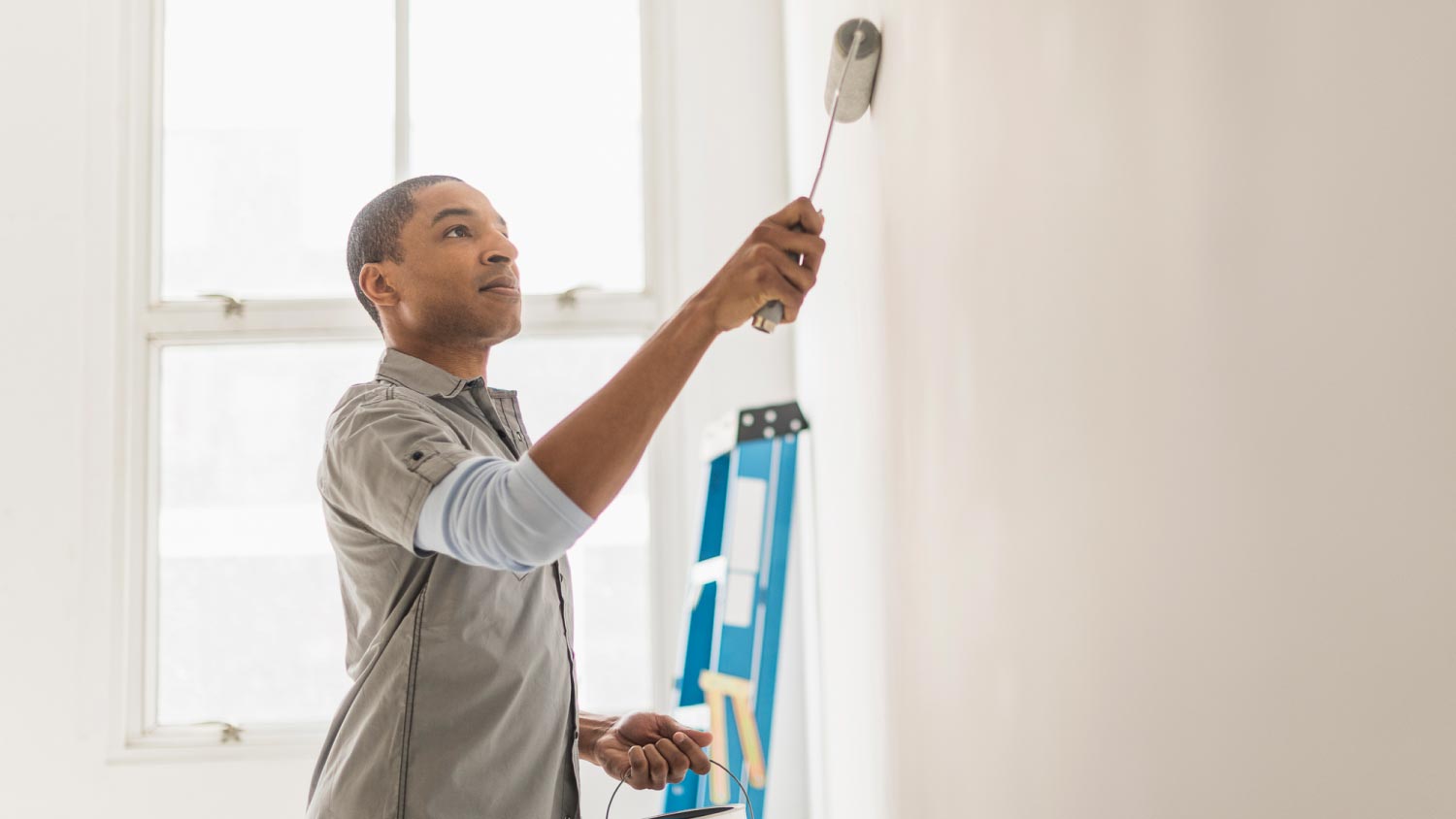 A man painting wall