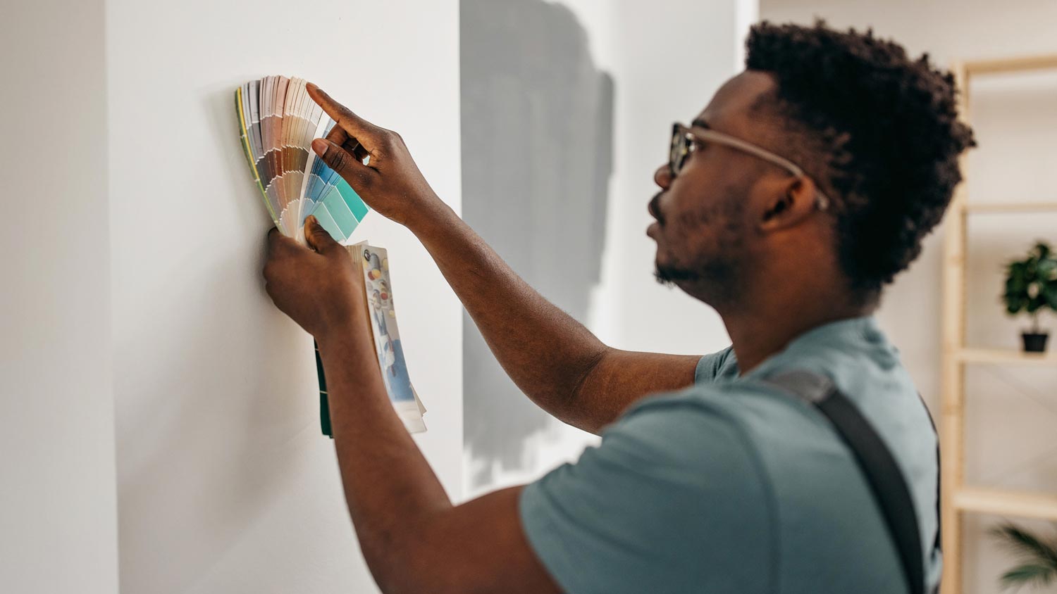 A man picking color to paint a wall