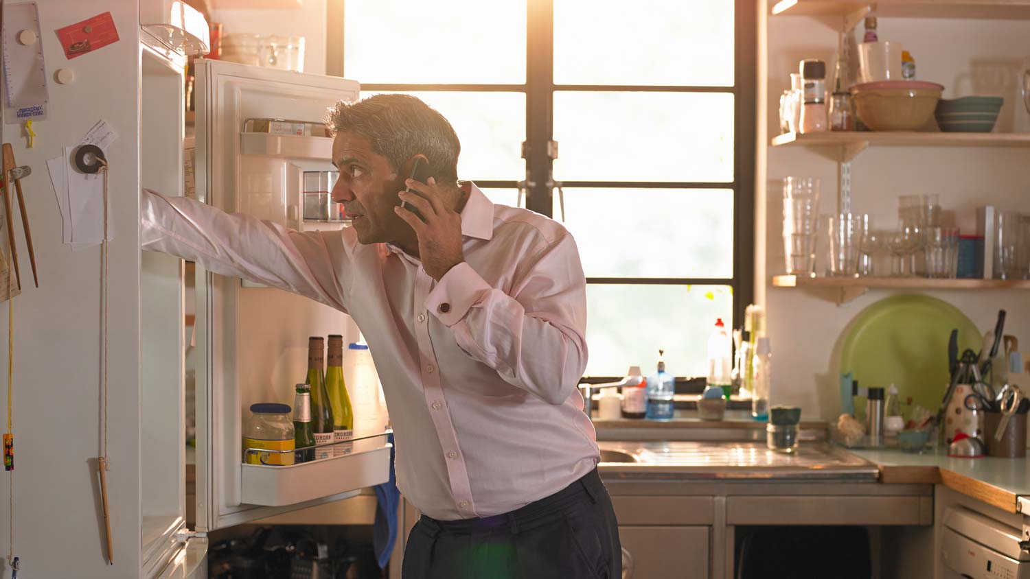 A man picking his meal from the refrigerator