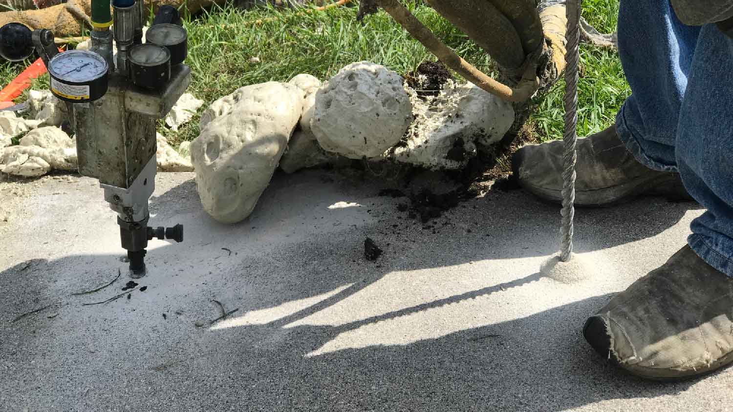 A man polyjacking a concrete slab