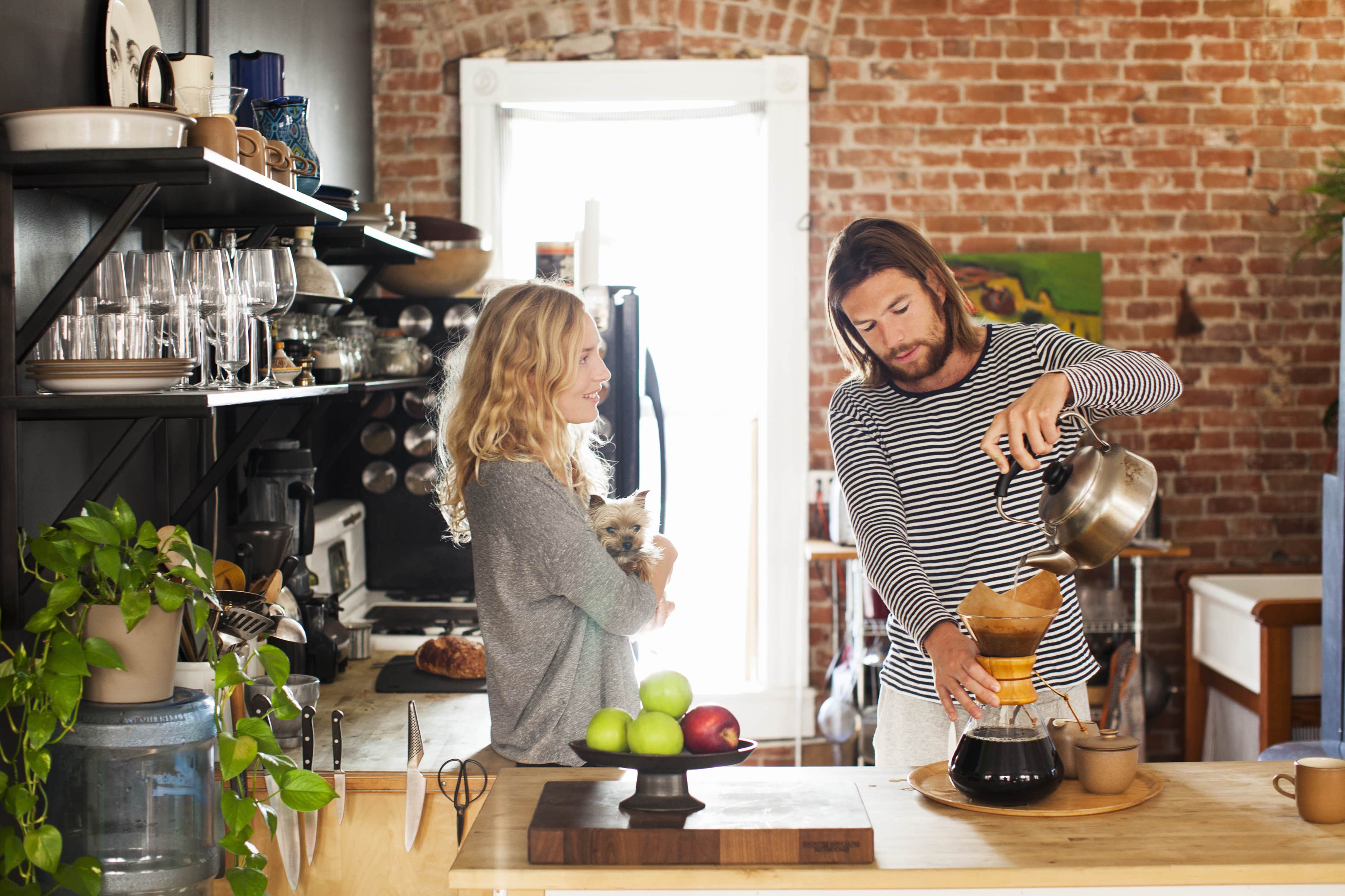 Couple in kitchen making coffee