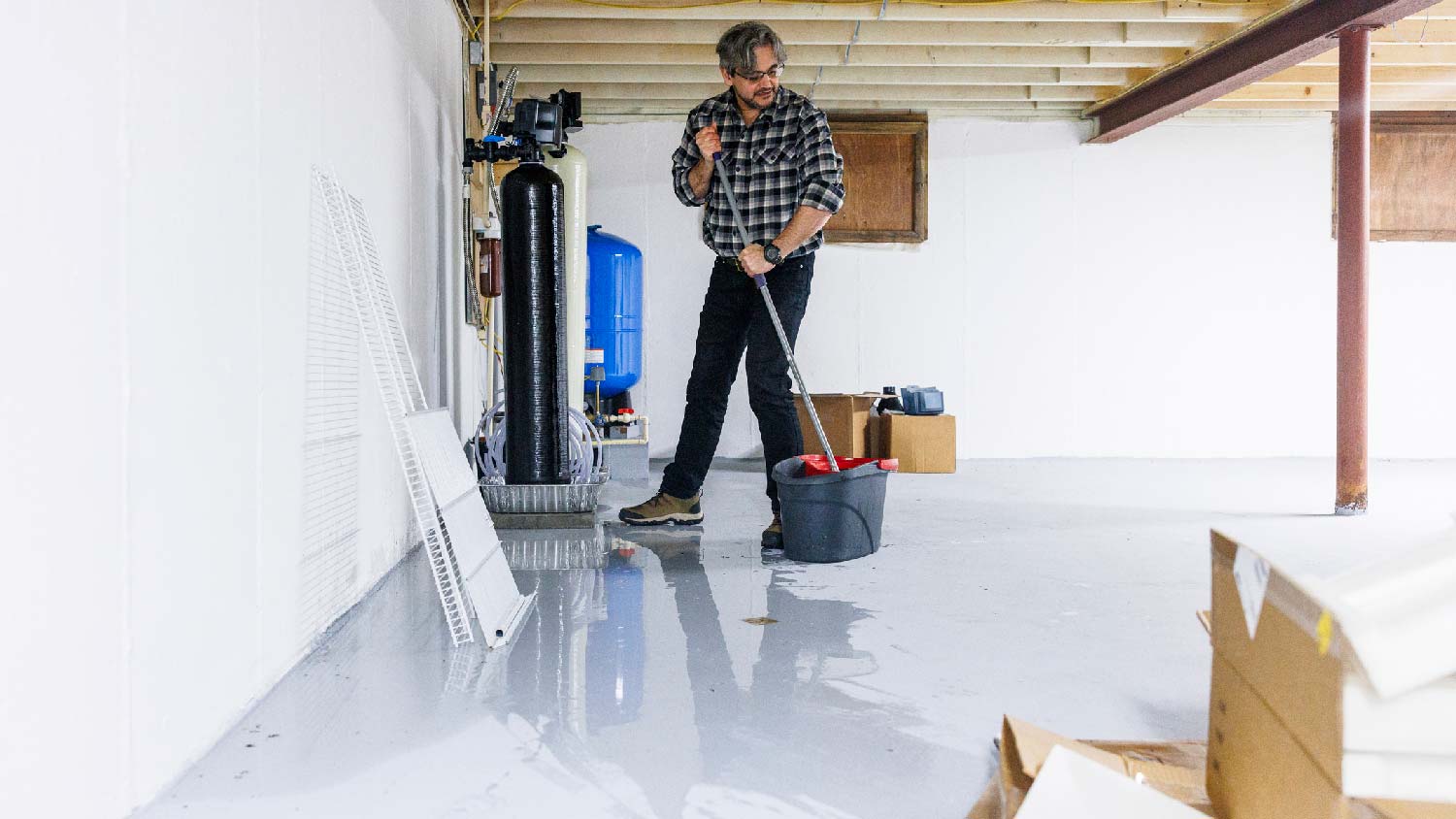 A man removing excess water from basement 