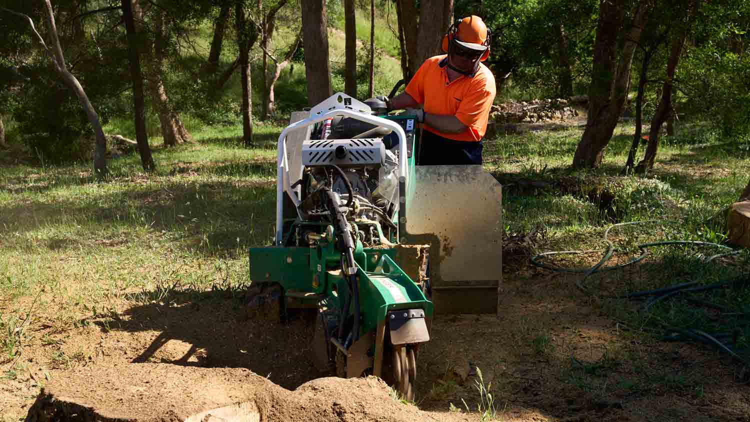 man removing machine stump with machine