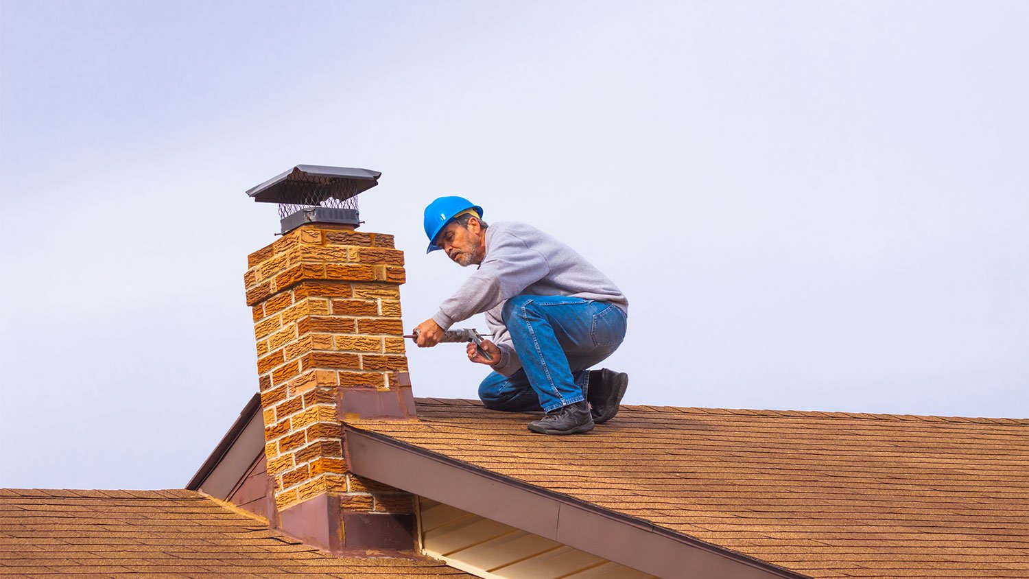 A man repairs a chimney