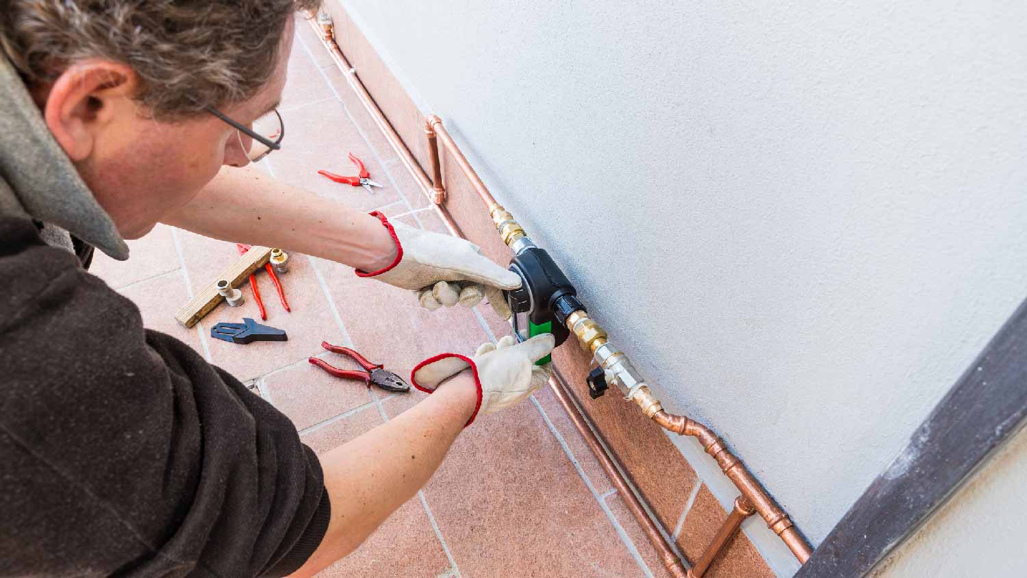 A man repairing an irrigation system controller