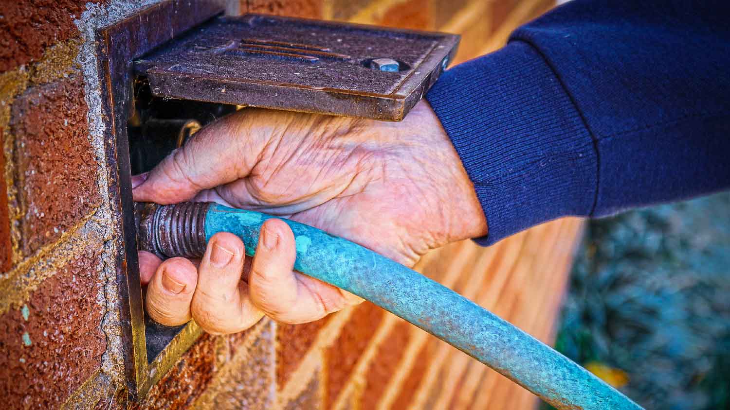 A man repairing an irrigation valve