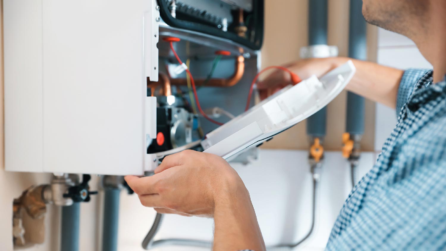 A man repairing a water heater