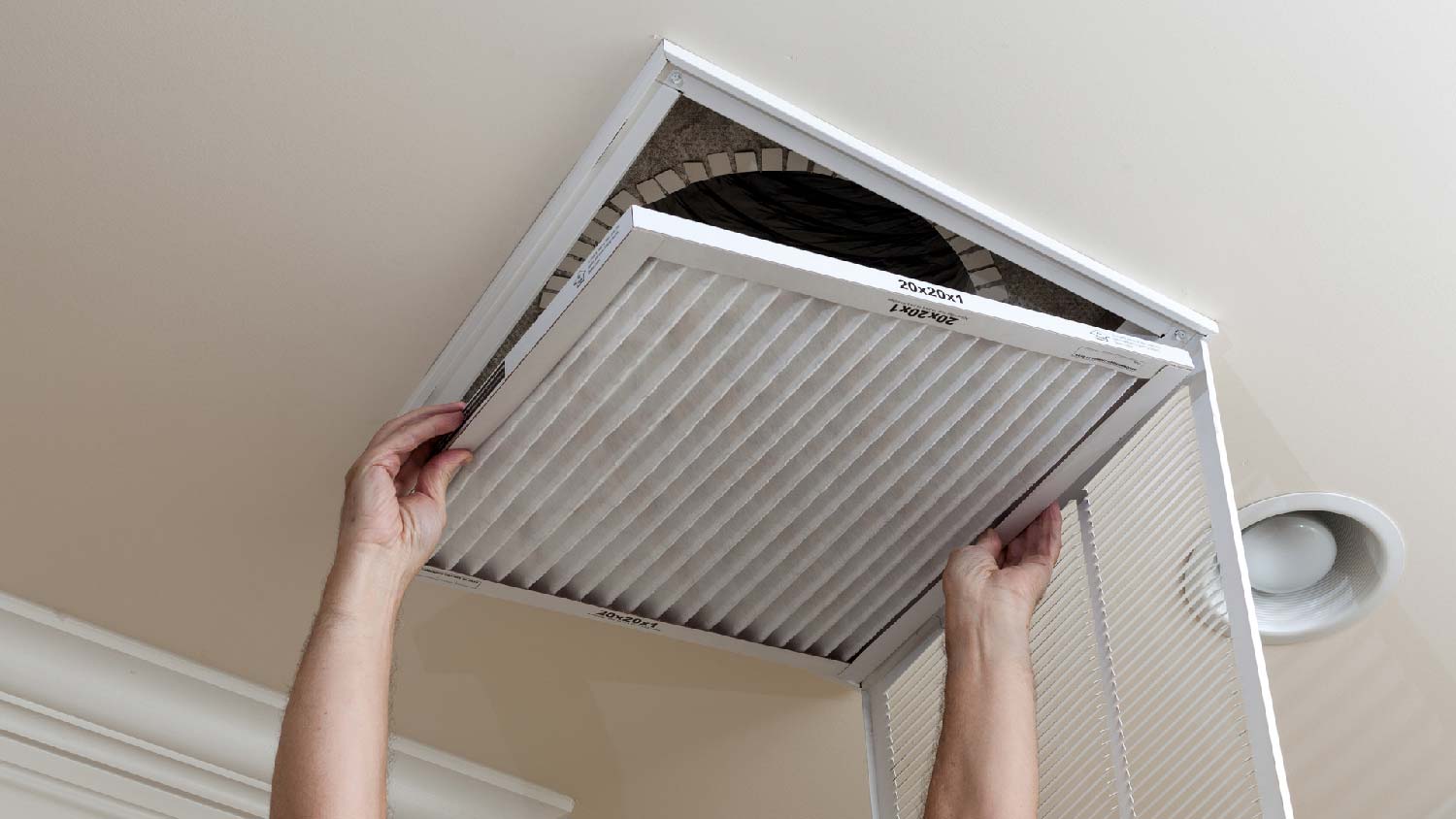 A man replacing an air filter