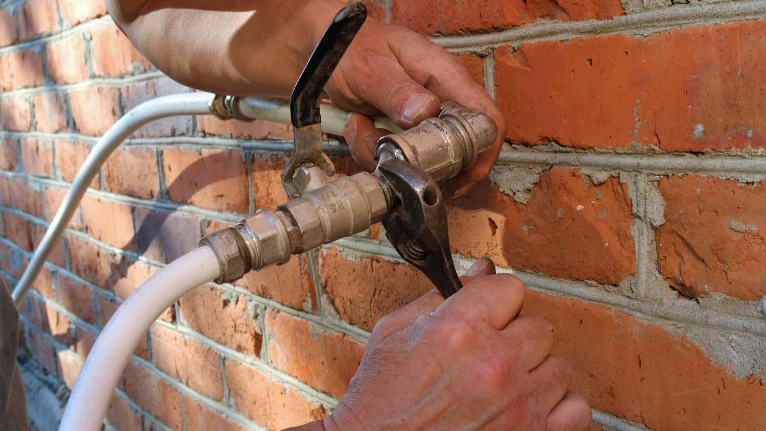 A man replacing a spigot valve 