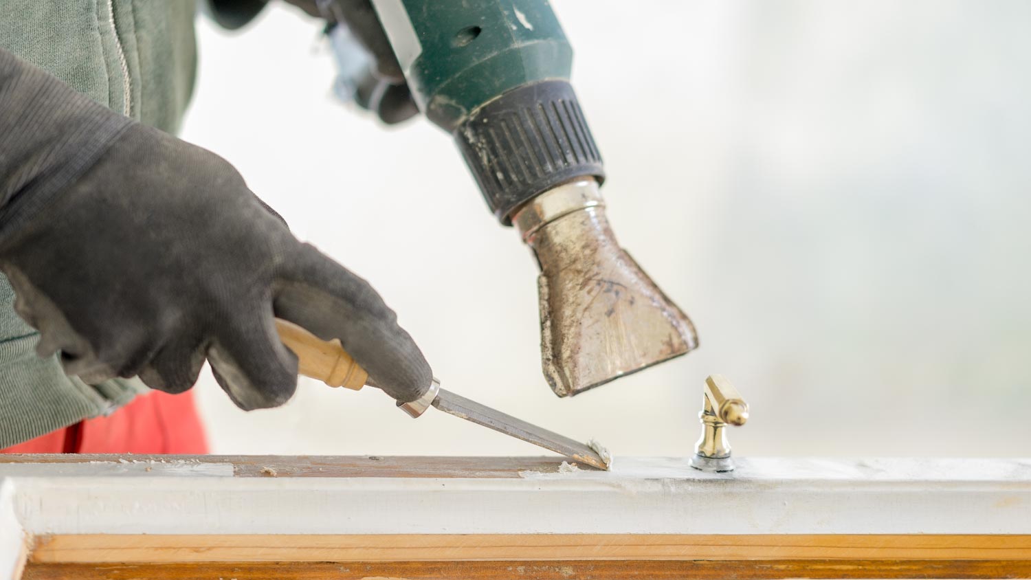 A man restoring a window frame