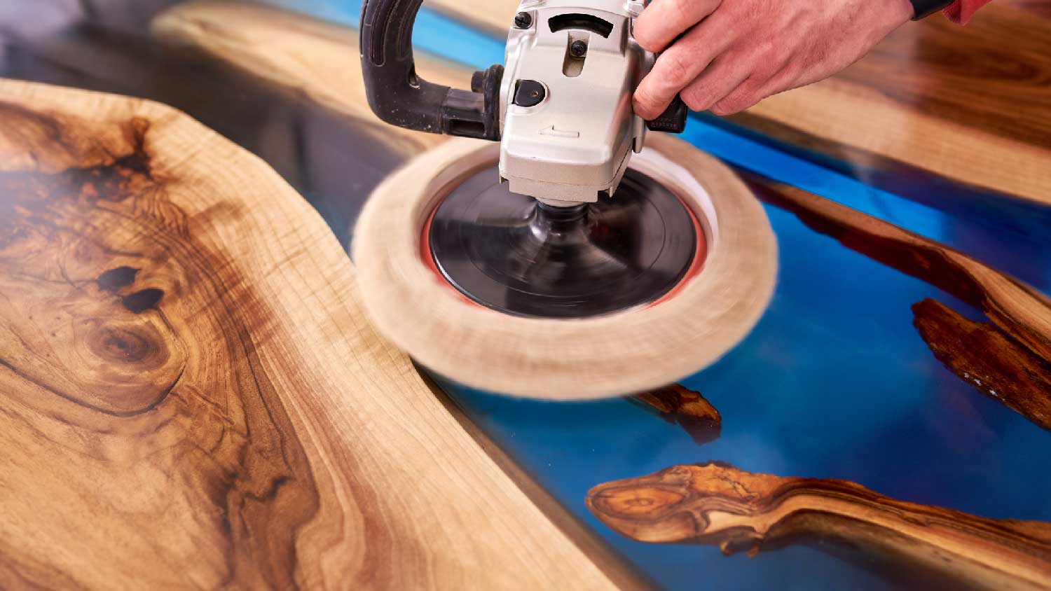 A man sanding an epoxy countertop