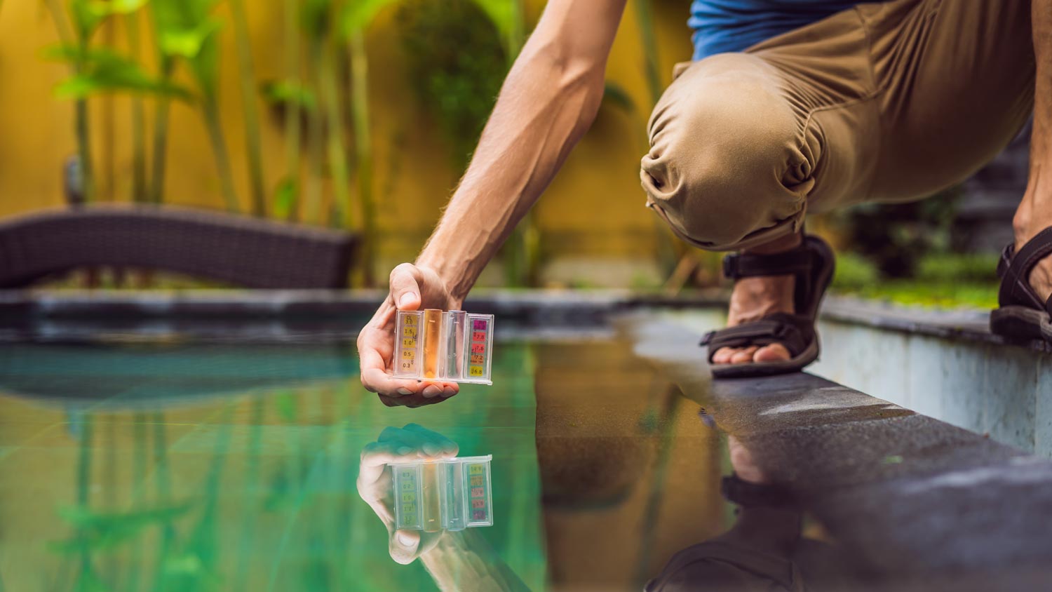 A man testing a pool’s pH