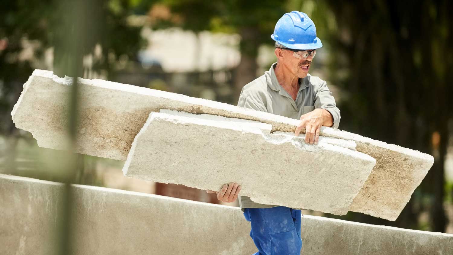 A man throwing away old insulation 