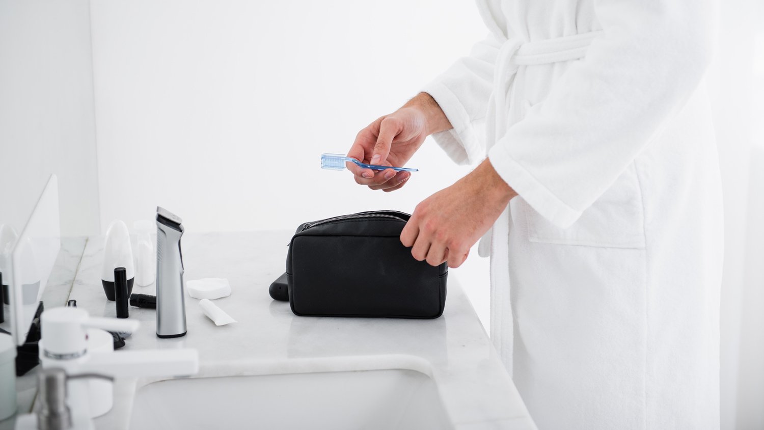 A man carrying his toiletries in a caddy