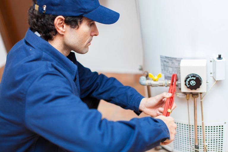 Man turning off water heater