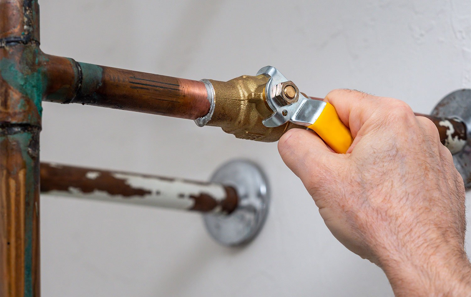 Male hand turning off water supply