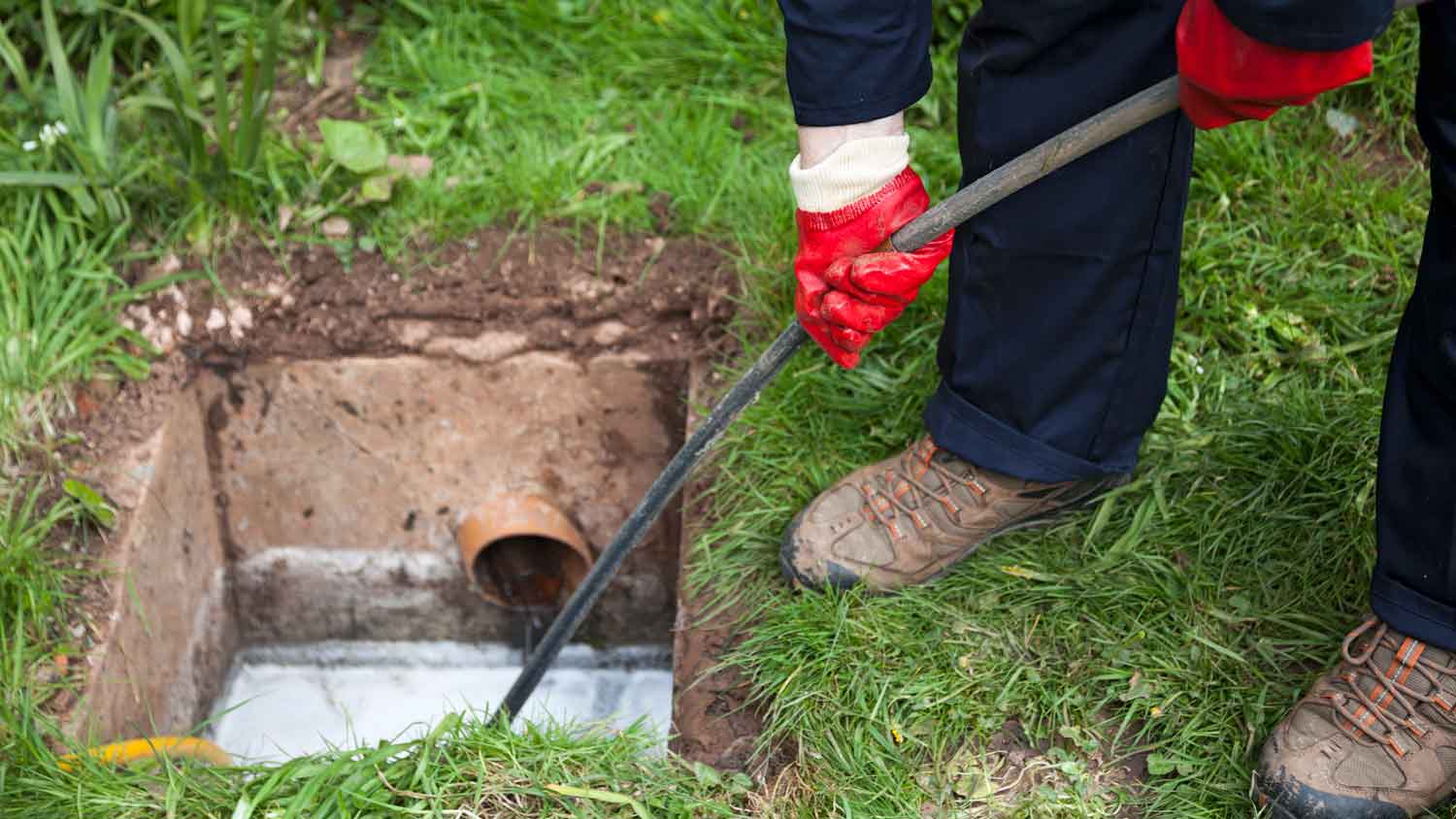 man unblocking drain