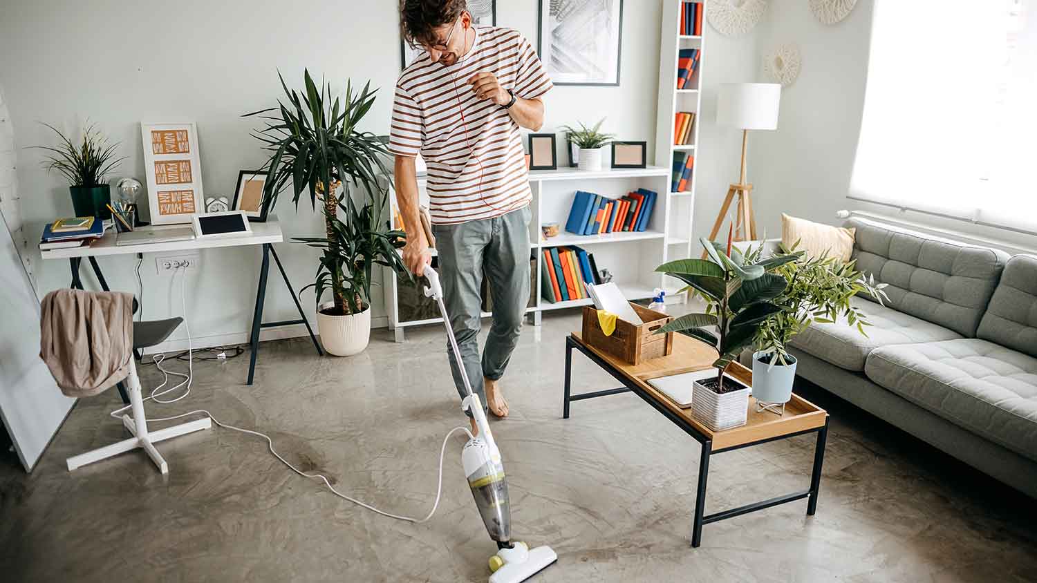 A man vacuuming a carpet