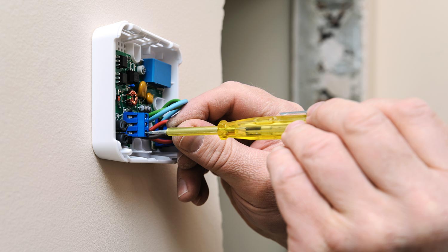 man wiring thermostat