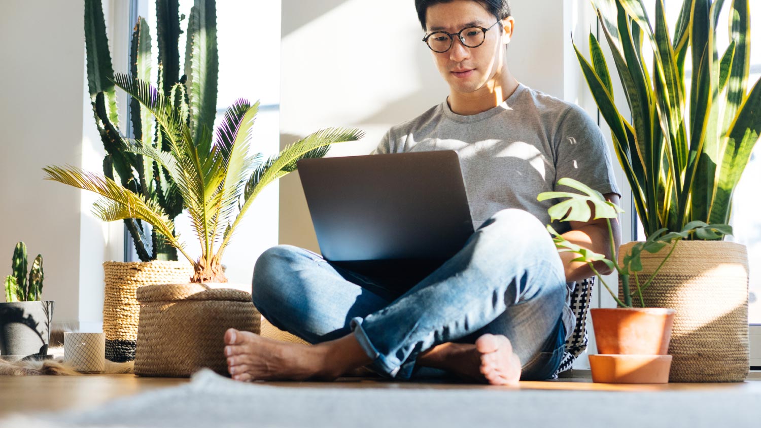 A man working at home and sitting on the floor