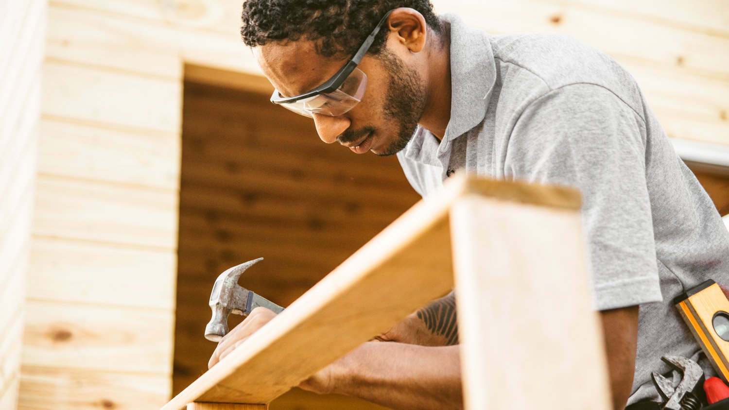 Construction worker nailing porch railing