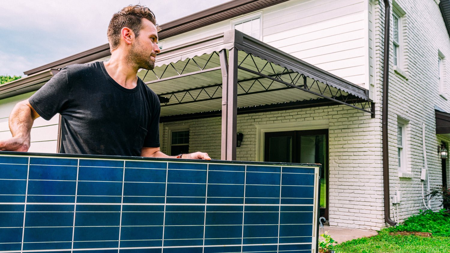 Man Carrying a Large Solar Panel